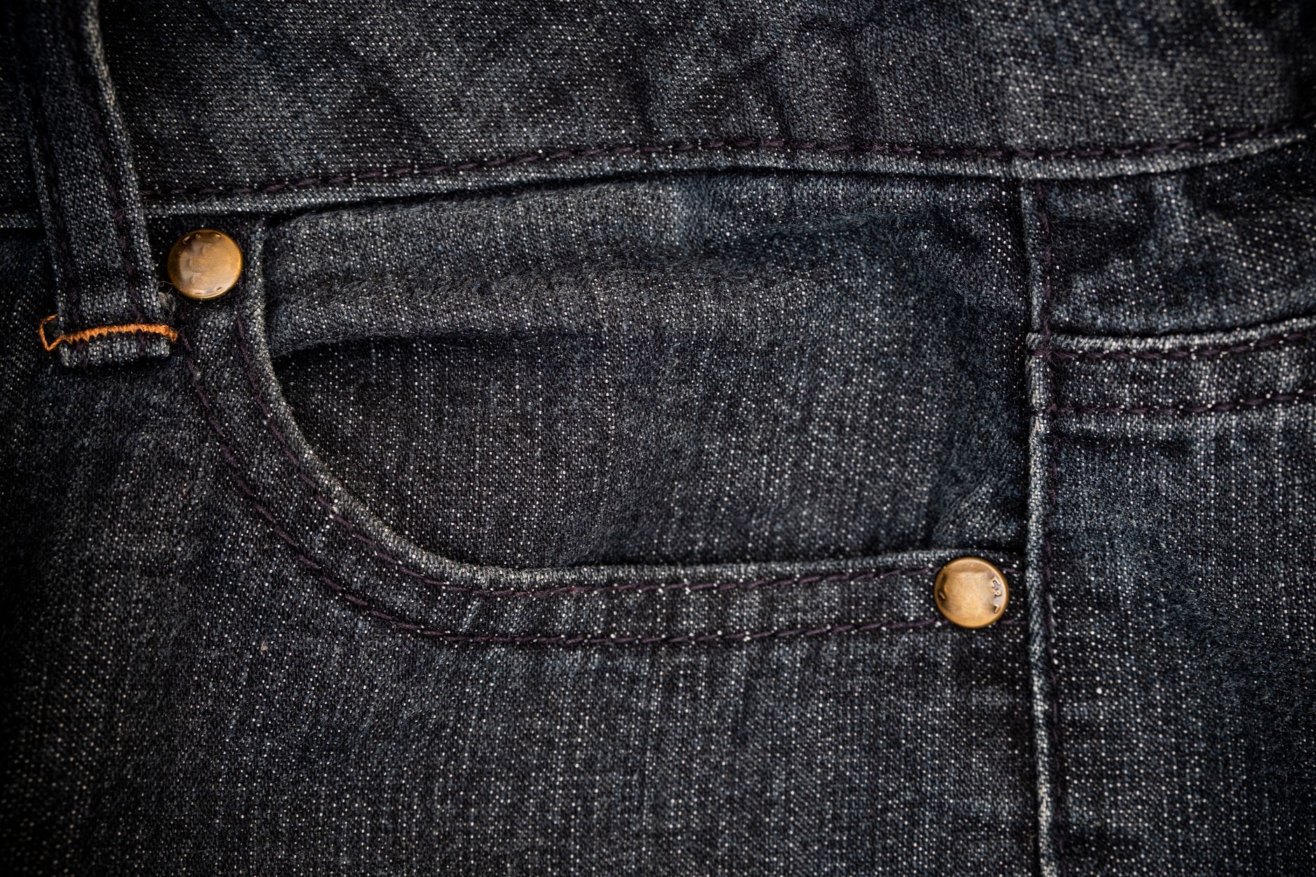 closeup view of blue jeans denim texture for traditional business background in cool vibrant colors